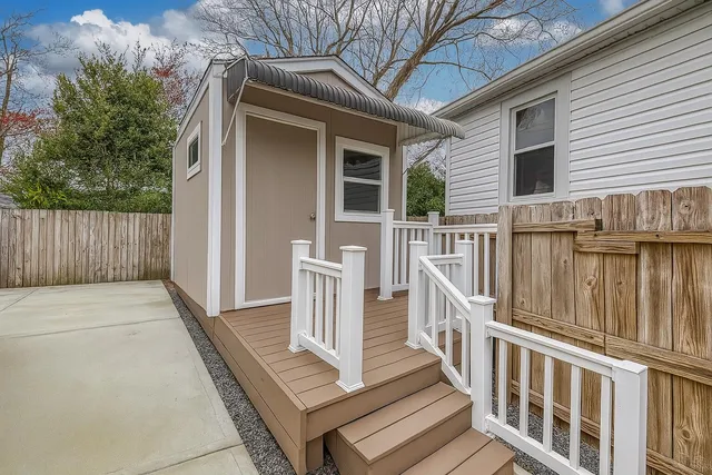 a view of a house with wooden fence