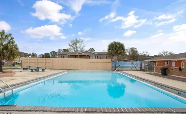 a view of a house with swimming pool and sitting area