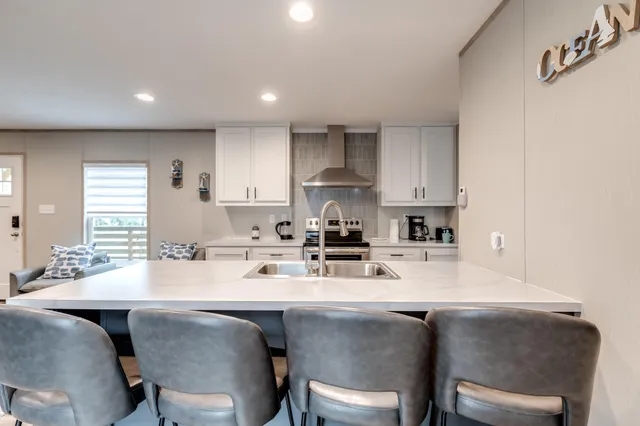 a kitchen with a dining table chairs and white appliances