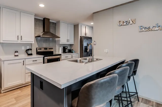 a kitchen with a stove a refrigerator and a table