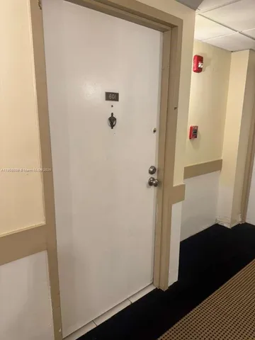 a bathroom with a shower and a wooden door