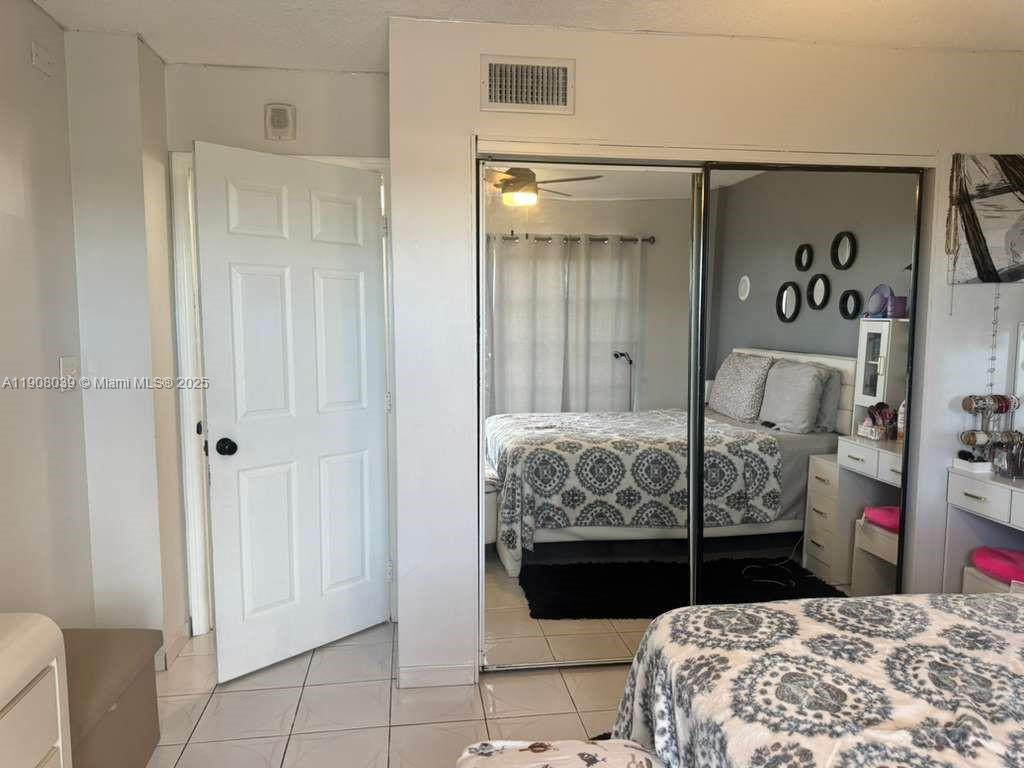 4164 Inverrary Drive, Unit 601 Lauderhill, FL 33319 - Photo 11 of 23 a bedroom with a bed and a table