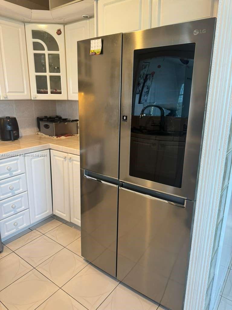 4164 Inverrary Drive, Unit 601 Lauderhill, FL 33319 - Photo 2 of 23 a kitchen with a refrigerator and cabinets