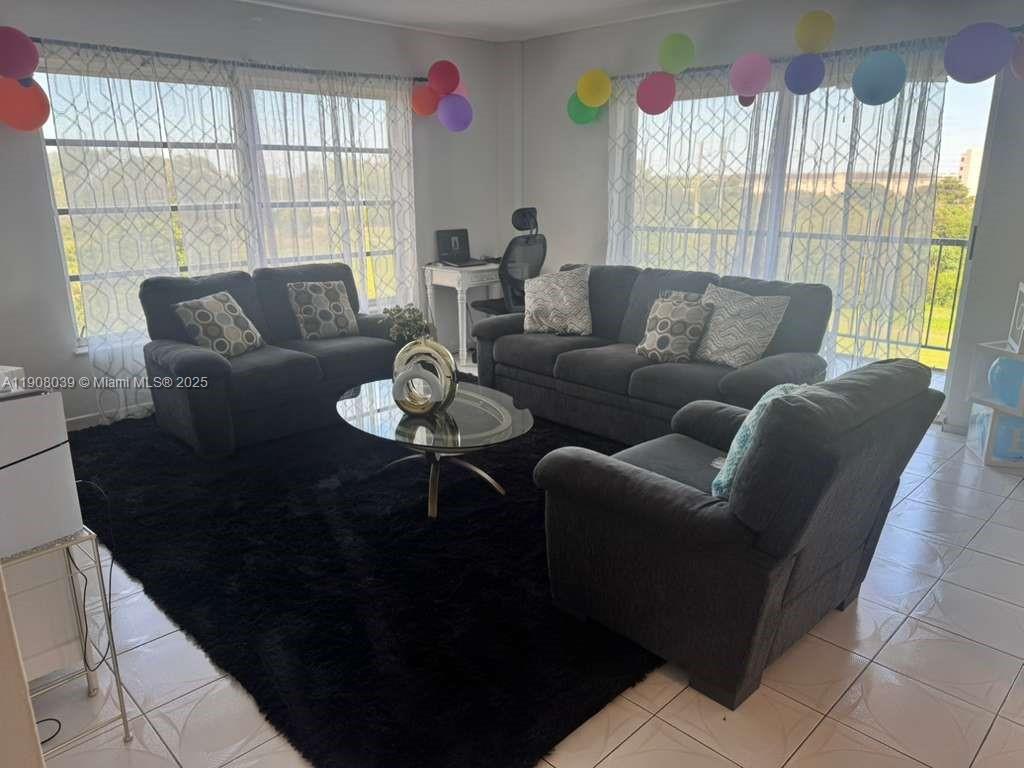 4164 Inverrary Drive, Unit 601 Lauderhill, FL 33319 - Photo 7 of 23 a living room with furniture and a large window