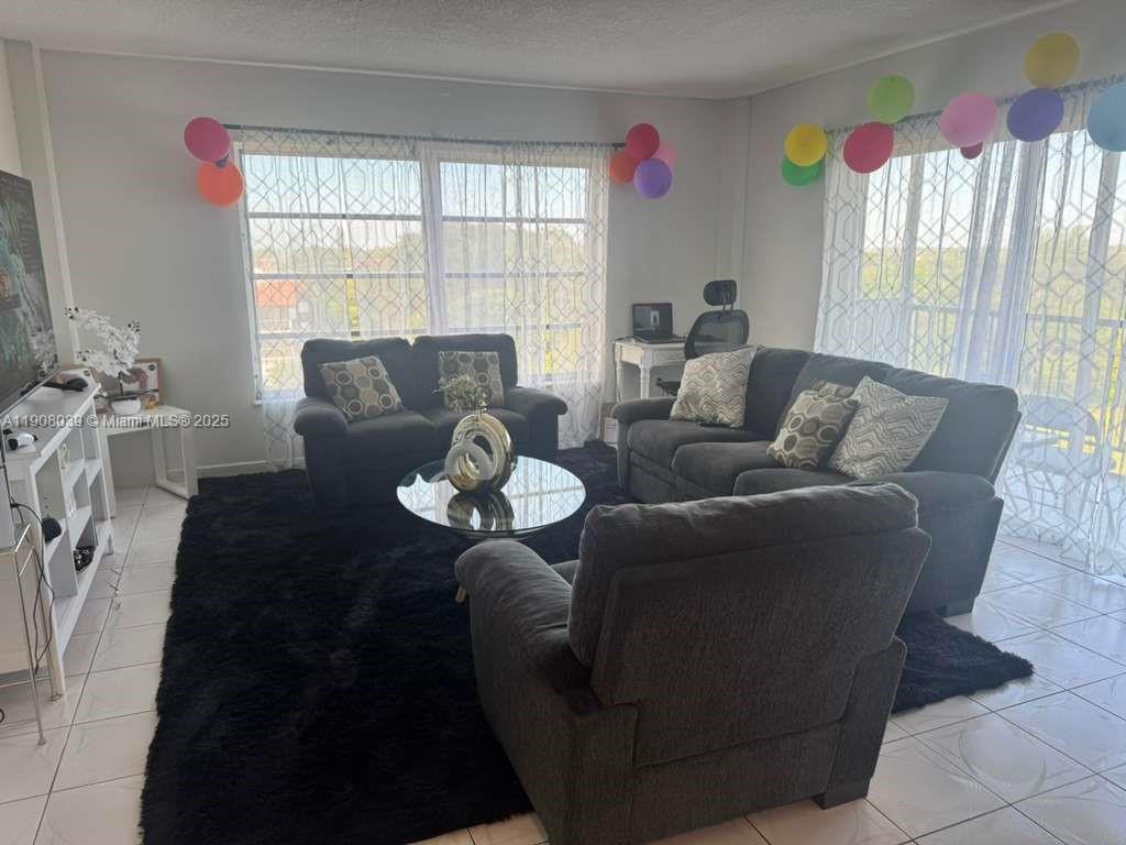 4164 Inverrary Drive, Unit 601 Lauderhill, FL 33319 - Photo 9 of 23 a living room with furniture and a large window