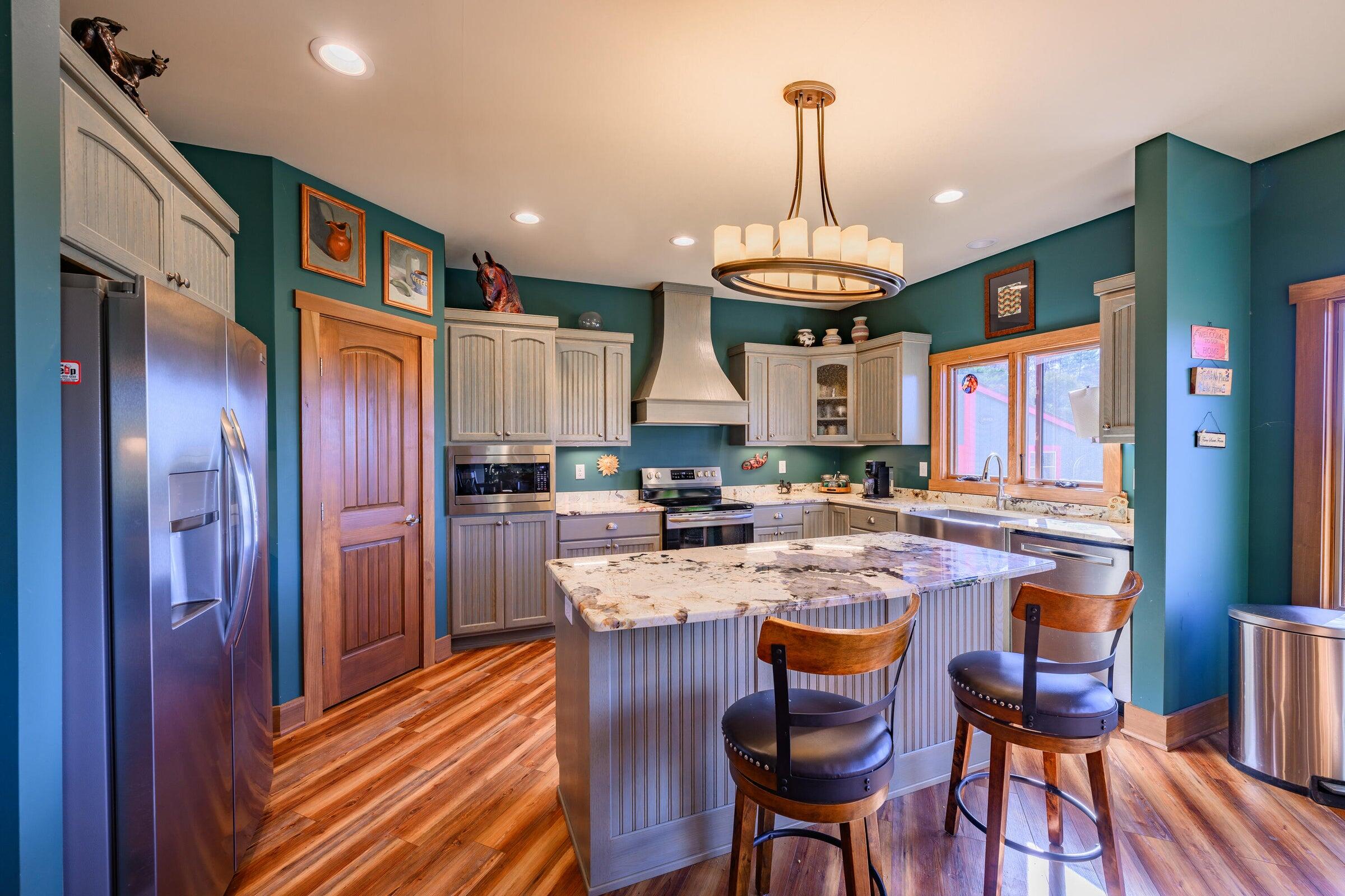 747 New Providence Road Raphine, VA 24472 - Photo 21 of 46 a kitchen with stainless steel appliances granite countertop wooden floors granite top and stove