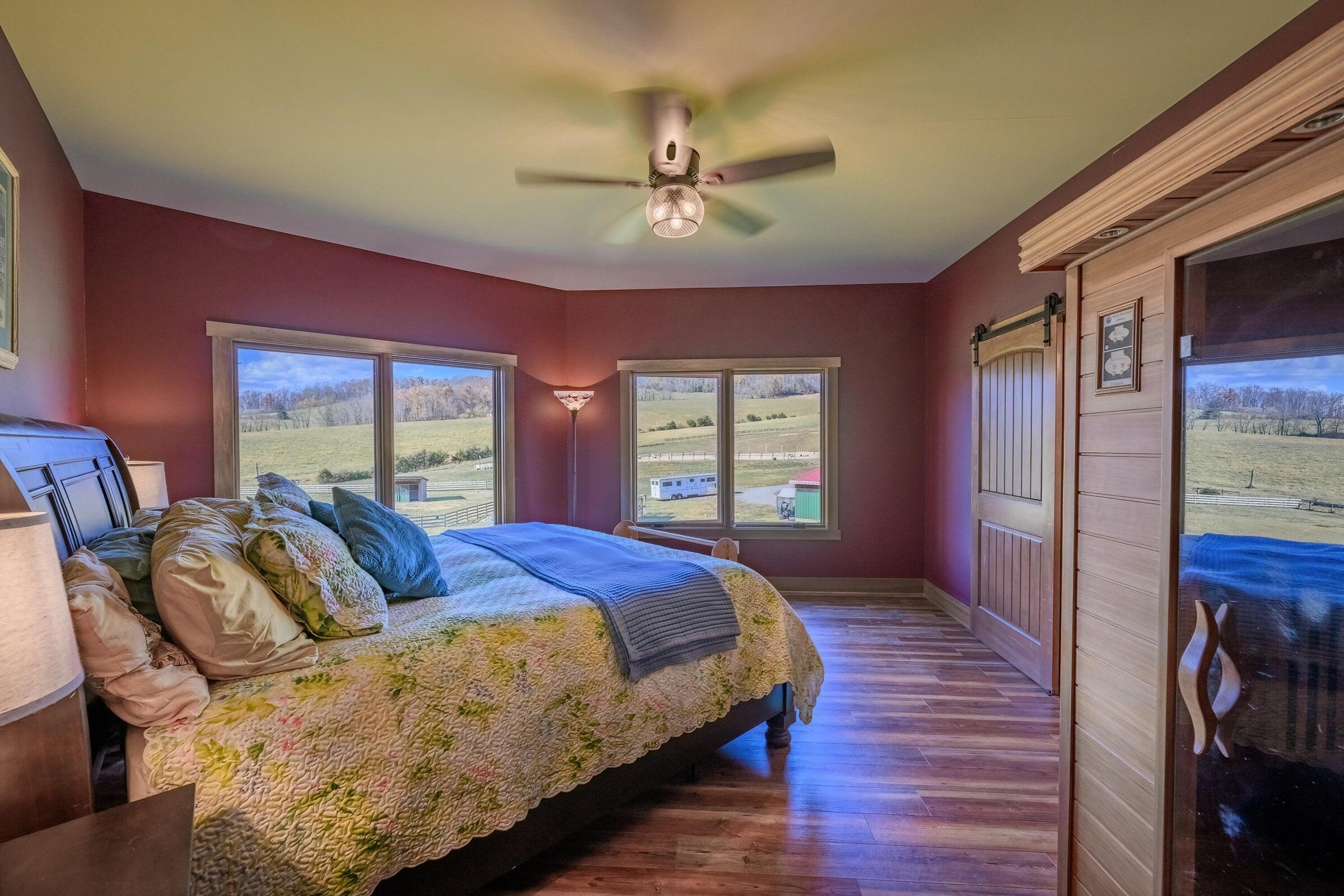 747 New Providence Road Raphine, VA 24472 - Photo 31 of 46 a spacious bedroom with a bed and wooden floor