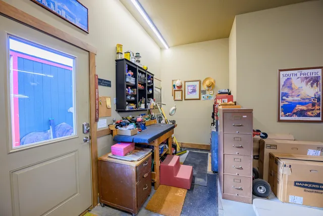 a view of a kitchen with fridge and workspace