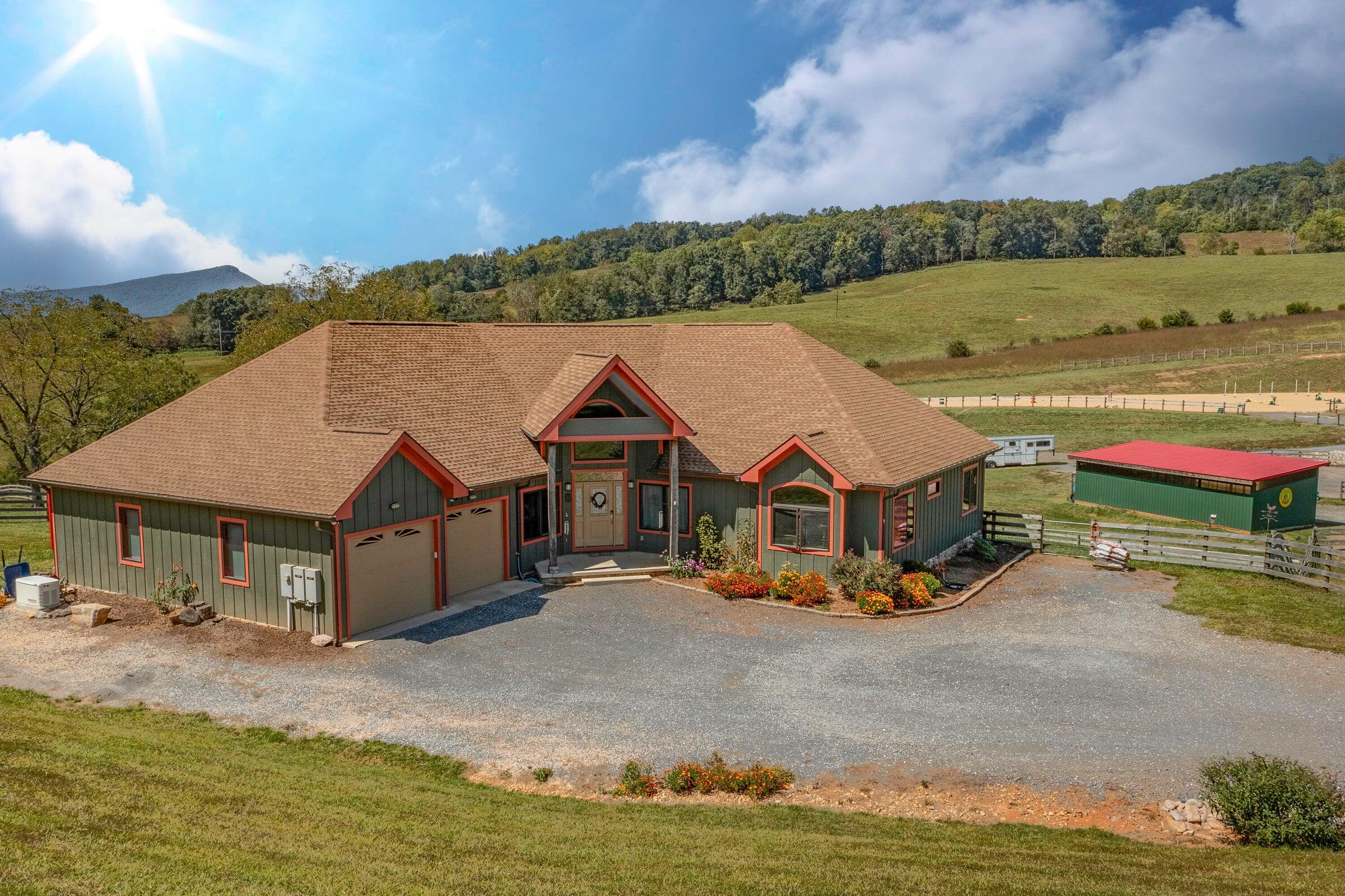 747 New Providence Road Raphine, VA 24472 - Photo 6 of 46 an aerial view of a house with a garden and lake view