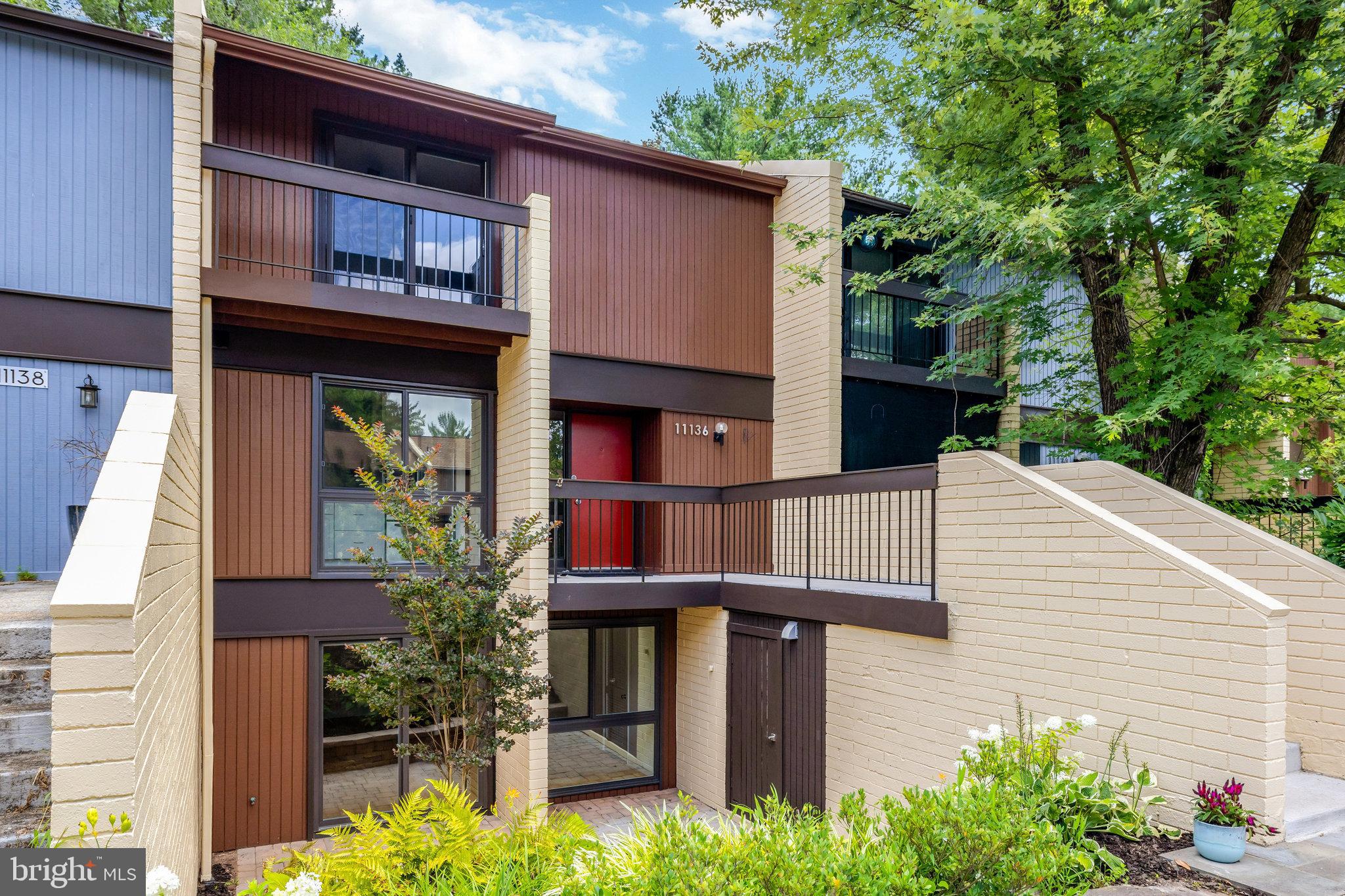 a view of a house with potted plants