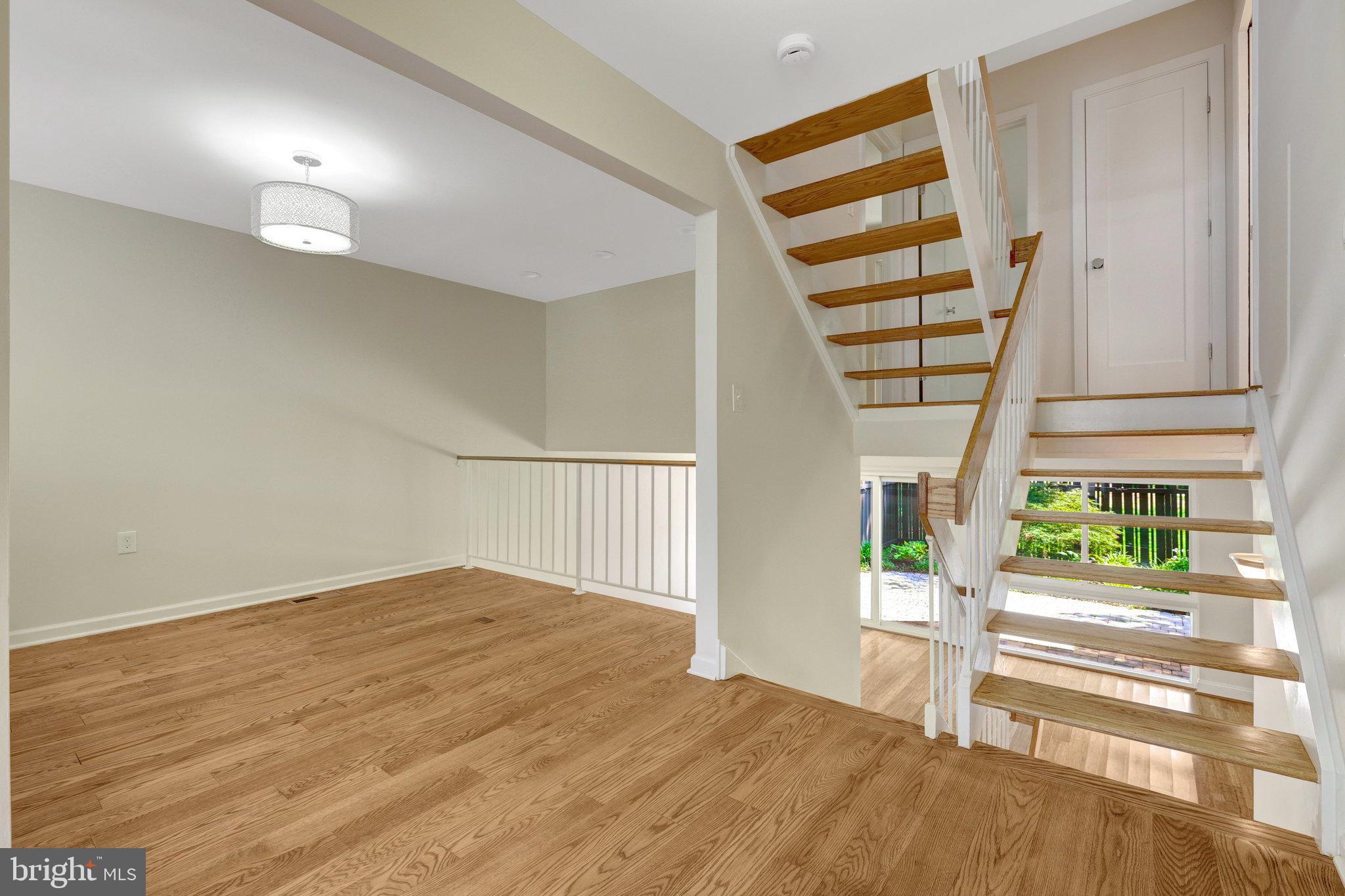11136 Saffold Way Reston, VA 20190 - Photo 12 of 49 a view of entryway with wooden floor and stairs