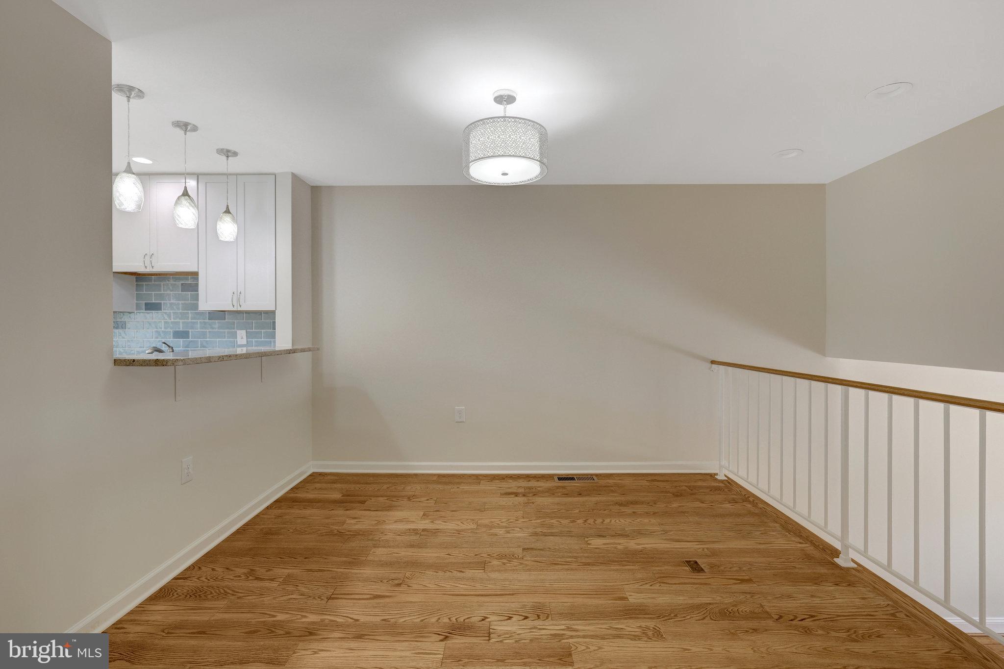 11136 Saffold Way Reston, VA 20190 - Photo 13 of 49 a view of empty room with wooden floor