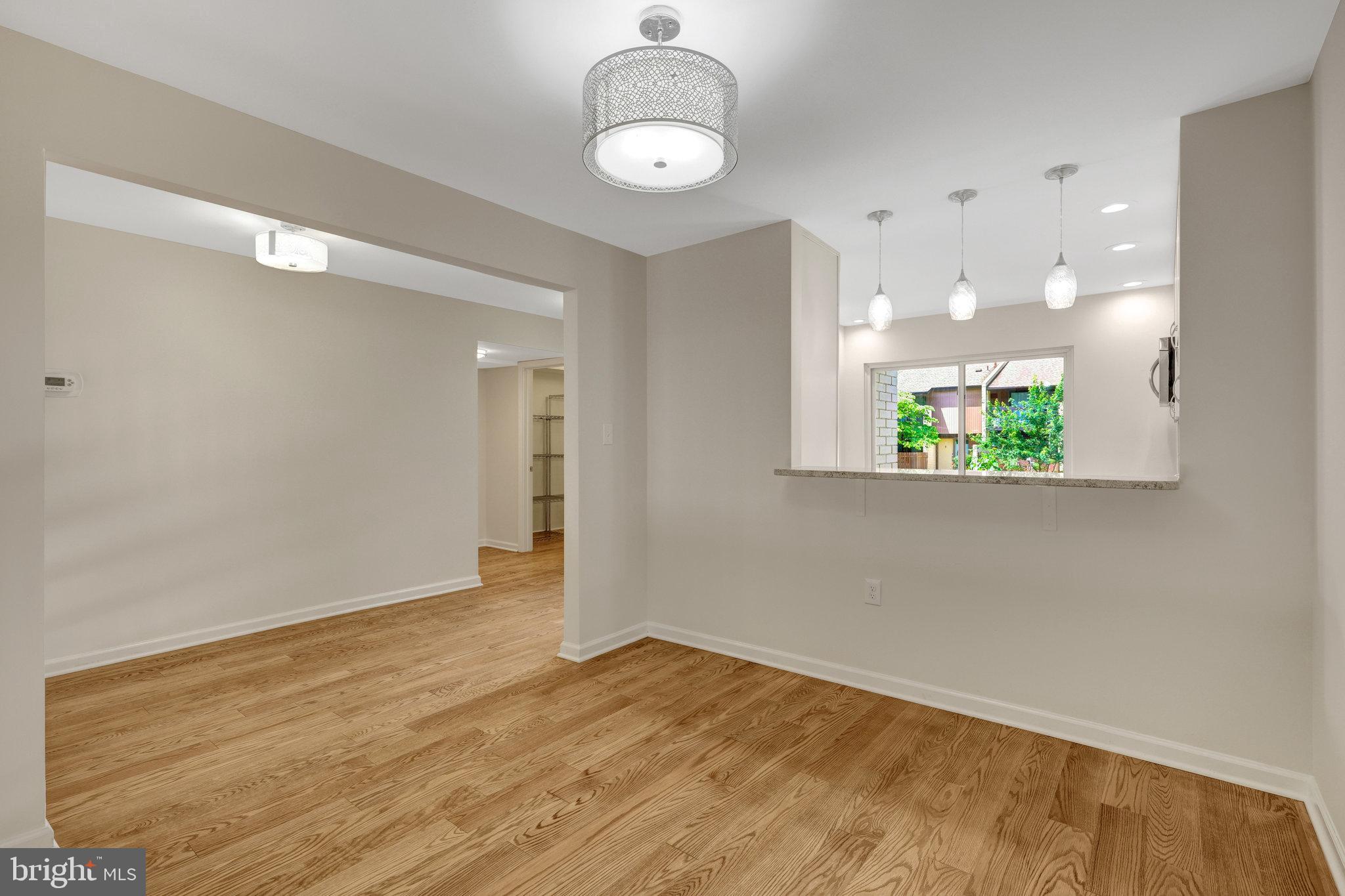11136 Saffold Way Reston, VA 20190 - Photo 15 of 49 wooden floor in an empty room with a window