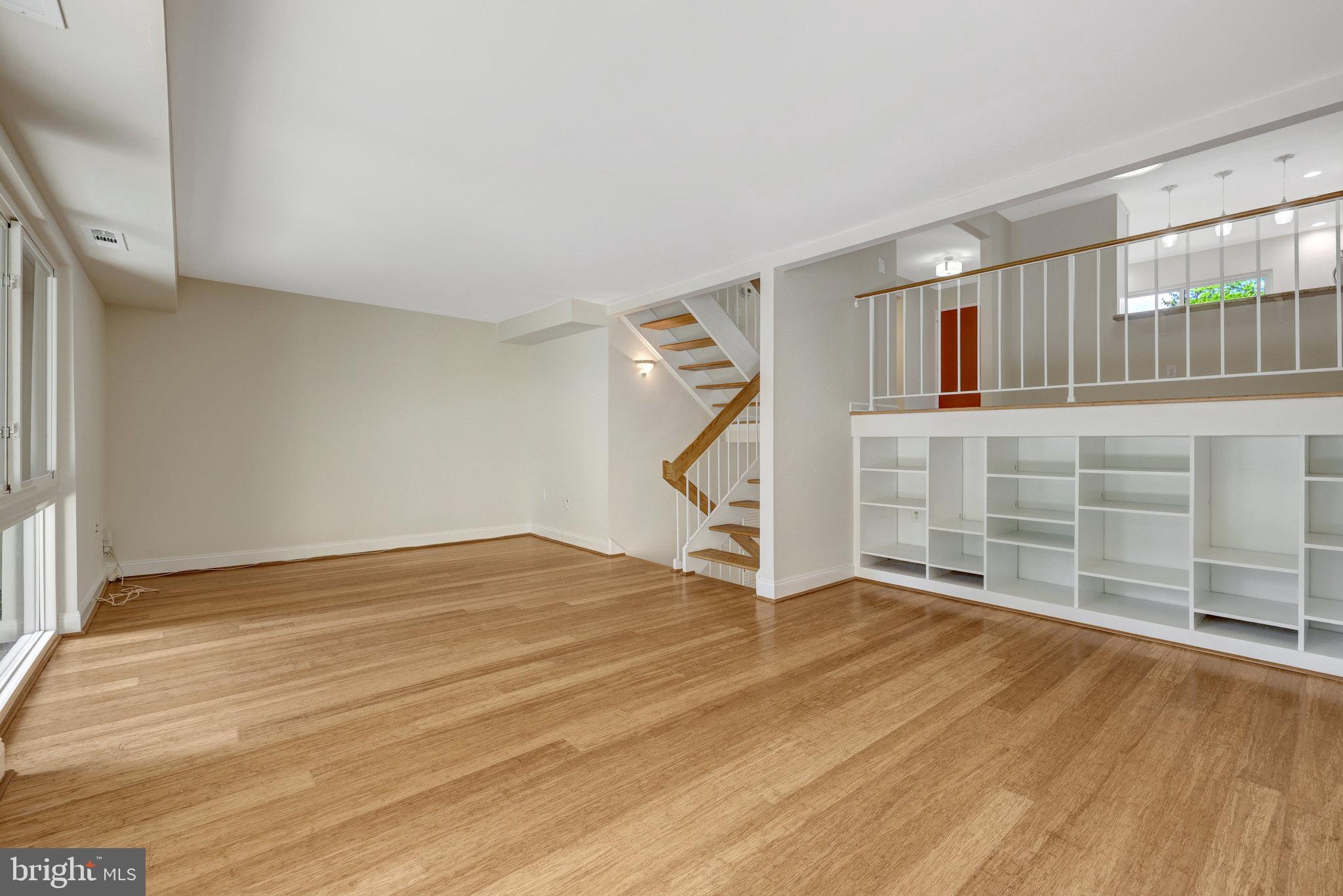 11136 Saffold Way Reston, VA 20190 - Photo 16 of 49 a view of an empty room with wooden floor and a window