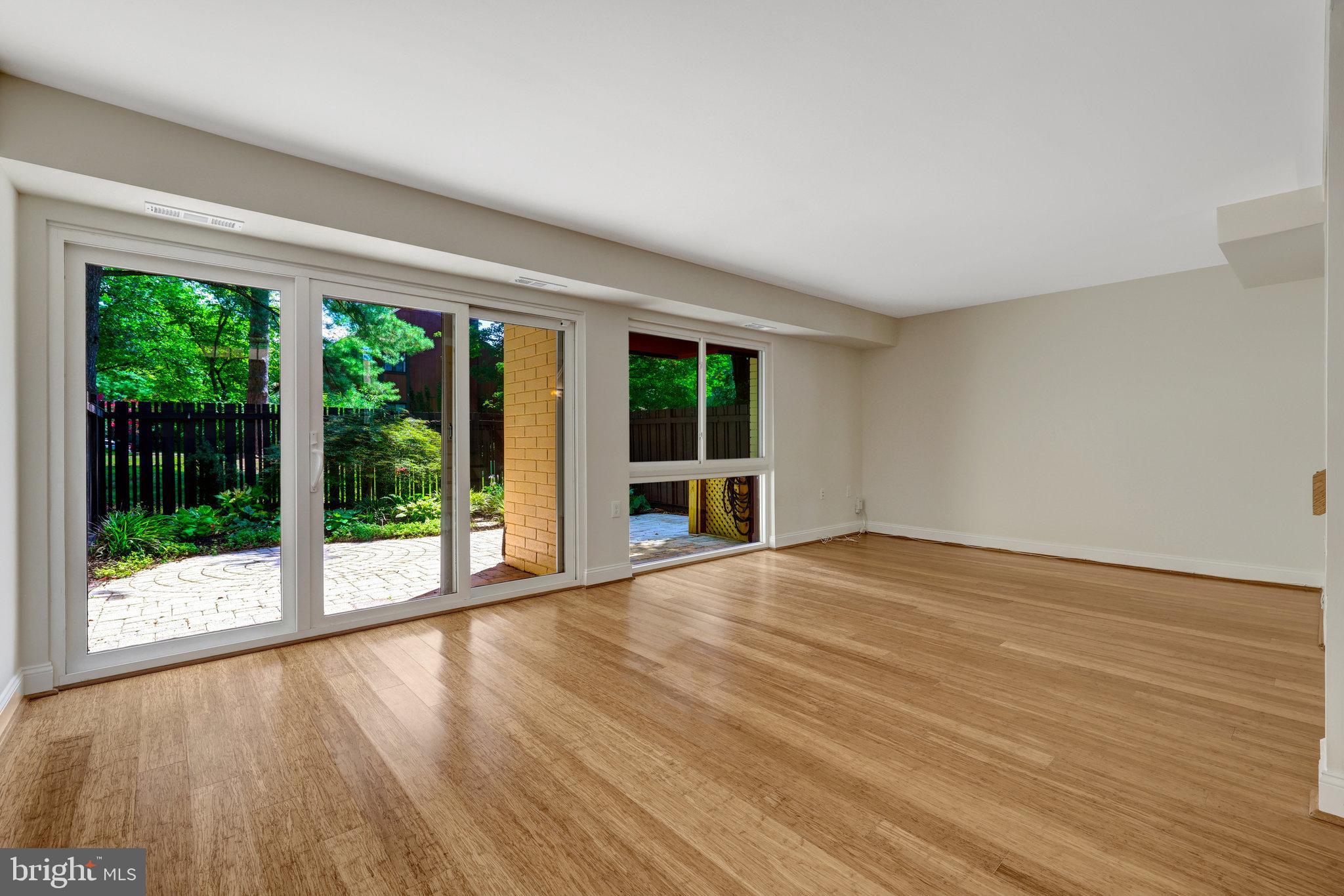 11136 Saffold Way Reston, VA 20190 - Photo 17 of 49 a view of an empty room with wooden floor and a window