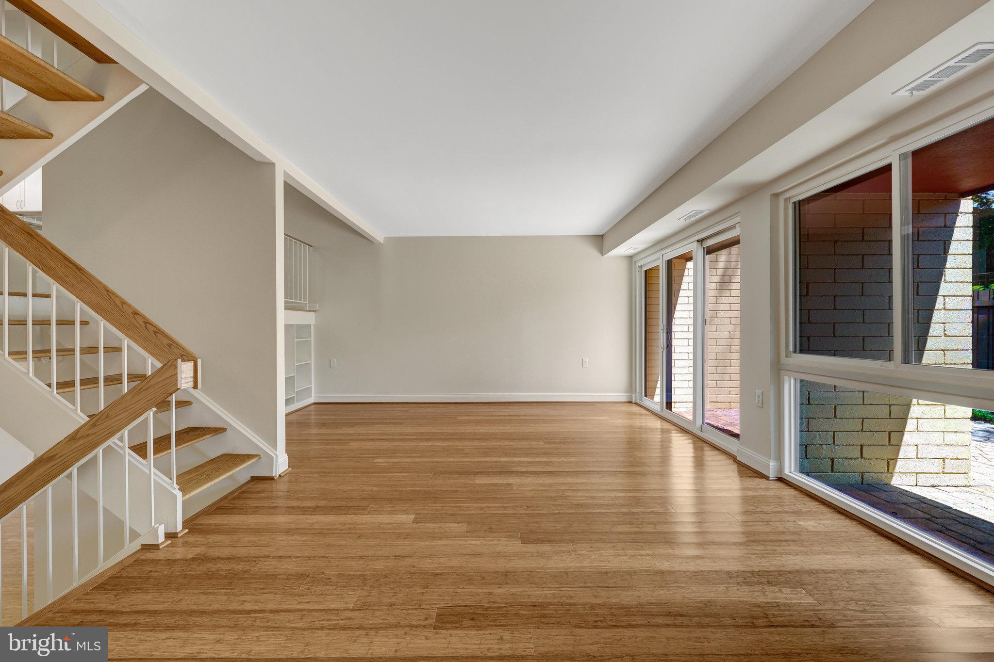 11136 Saffold Way Reston, VA 20190 - Photo 19 of 49 a view of an empty room with wooden floor and a window