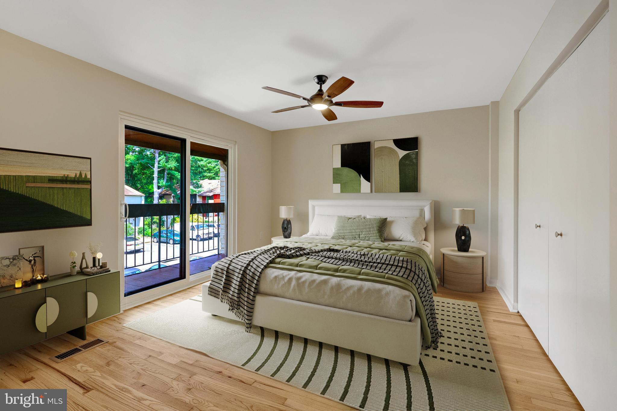 11136 Saffold Way Reston, VA 20190 - Photo 27 of 49 a bedroom with a bed and wooden floor