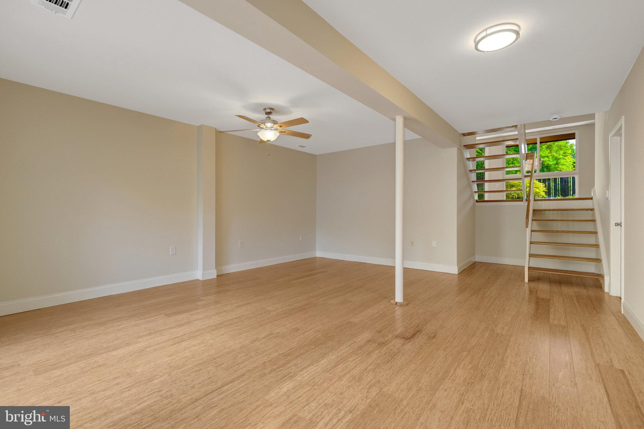 11136 Saffold Way Reston, VA 20190 - Photo 35 of 49 an empty room with wooden floor and windows