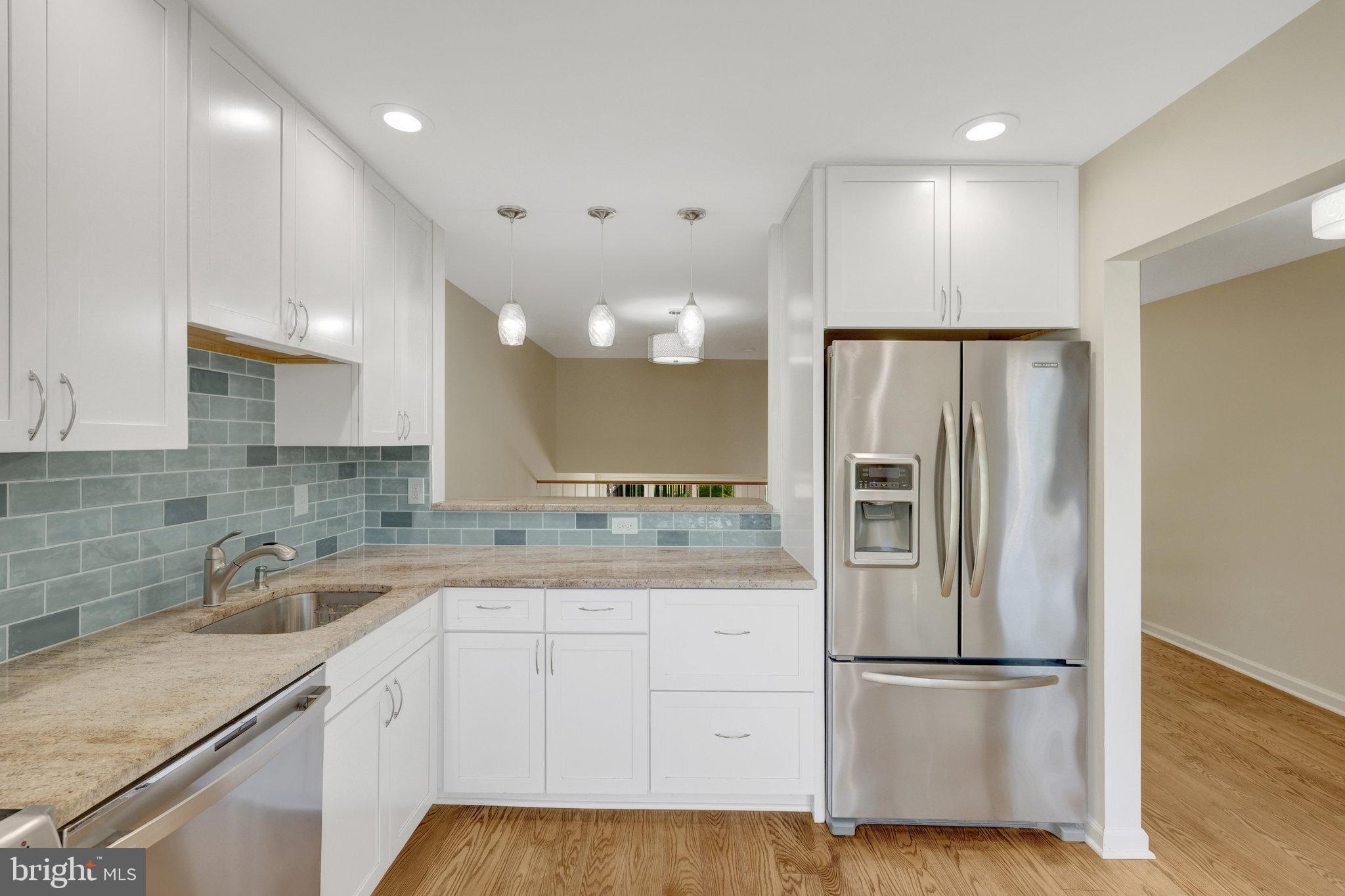 11136 Saffold Way Reston, VA 20190 - Photo 8 of 49 a kitchen with a refrigerator sink and cabinets