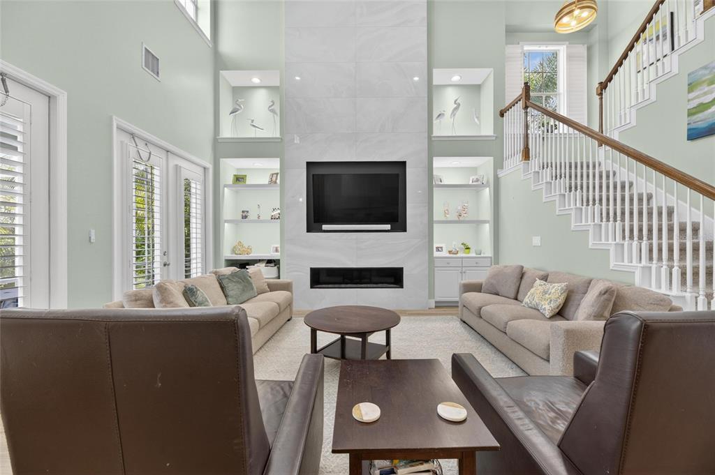 508 Islebay Drive Apollo Beach, FL 33572 - Photo 20 of 98 a living room with furniture a fireplace and a flat screen tv