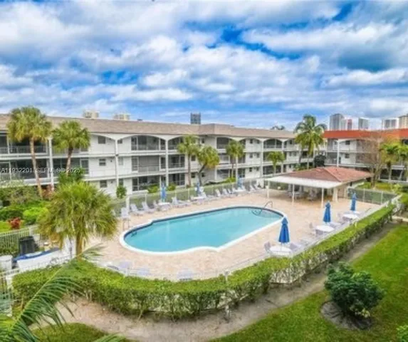 a view of a swimming pool with outdoor seating