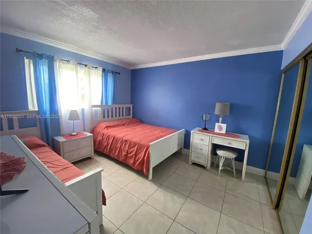 a bedroom with a bed and a table in it