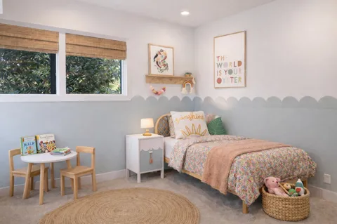 a spacious bedroom with two beds and a large window