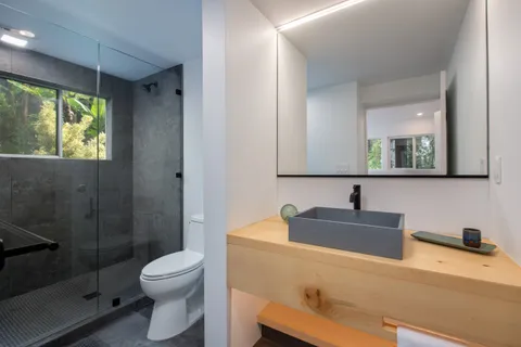 a bed sitting in a bedroom next to a window