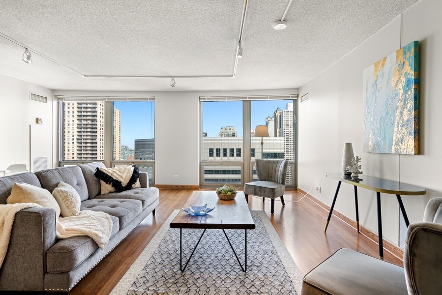 440 North Wabash Avenue, Unit 4706 Chicago, IL 60611 - Photo 2 of 29 a living room with furniture and a table