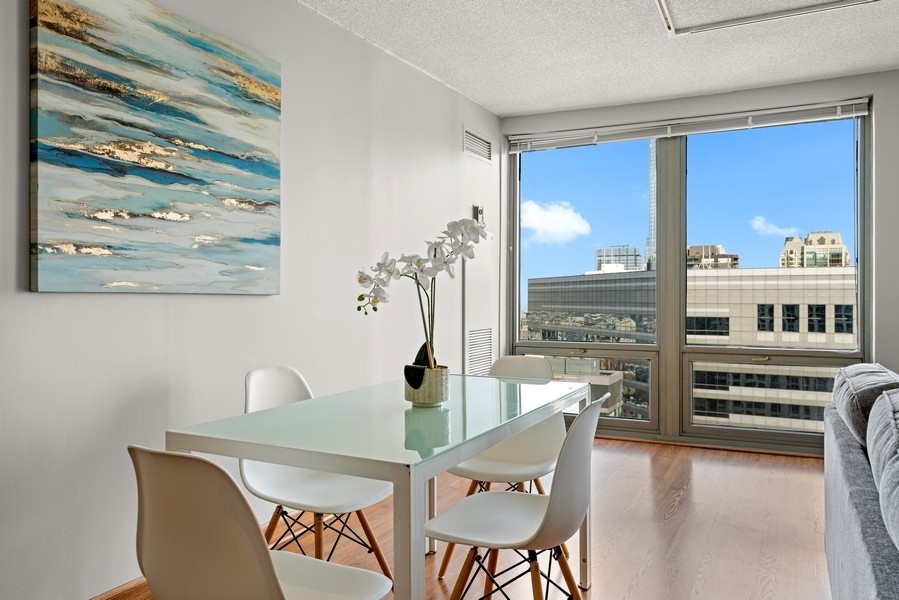 440 North Wabash Avenue, Unit 4706 Chicago, IL 60611 - Photo 11 of 29 a dining room with furniture and window