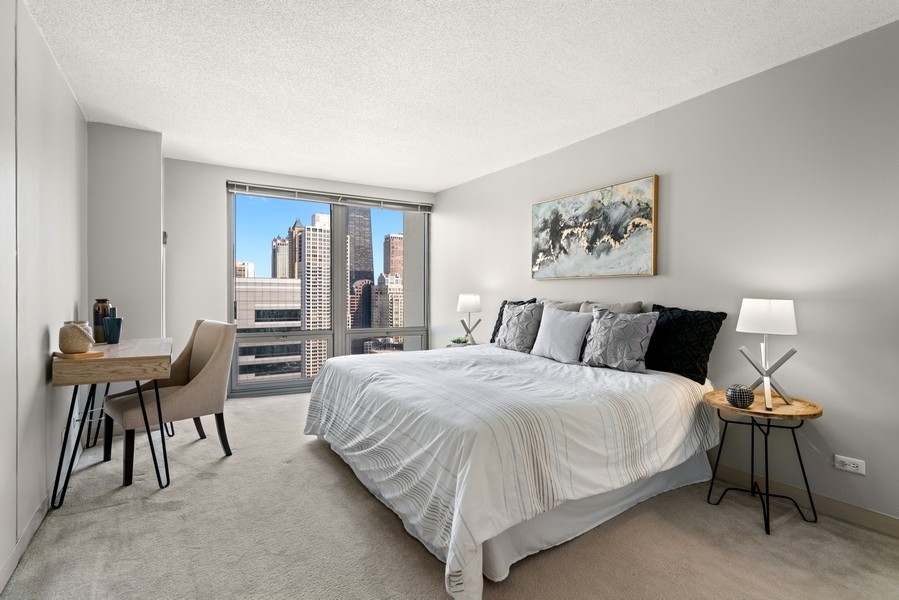 440 North Wabash Avenue, Unit 4706 Chicago, IL 60611 - Photo 12 of 29 a bedroom with a bed and a table