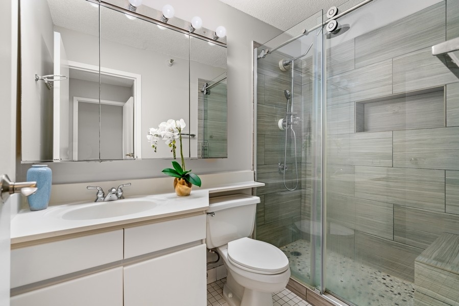 440 North Wabash Avenue, Unit 4706 Chicago, IL 60611 - Photo 14 of 29 a bathroom with a sink toilet and shower