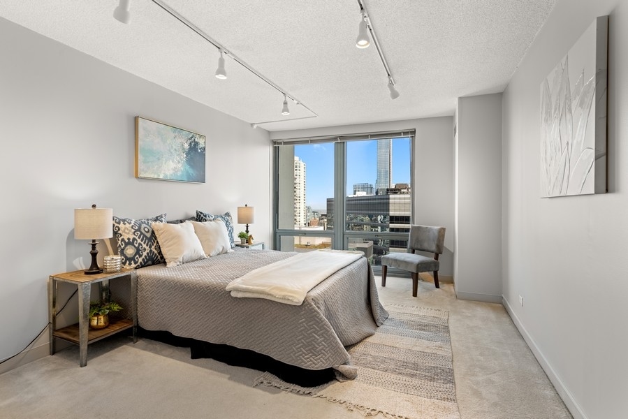 440 North Wabash Avenue, Unit 4706 Chicago, IL 60611 - Photo 15 of 29 a bedroom with a bed and a table