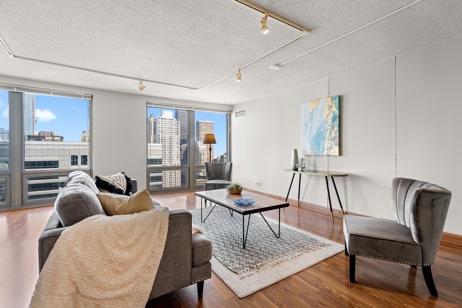 440 North Wabash Avenue, Unit 4706 Chicago, IL 60611 - Photo 4 of 29 a living room with furniture and wooden floor