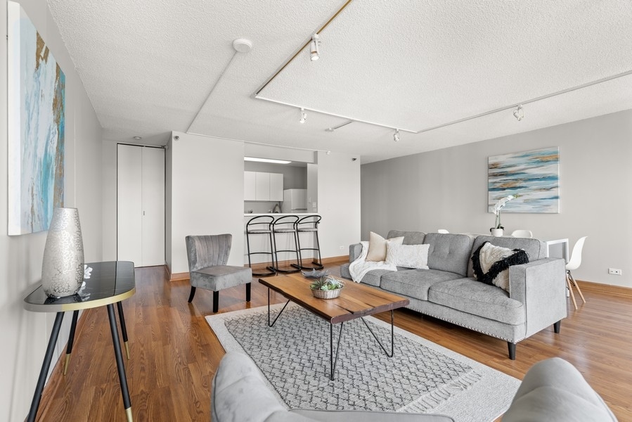 440 North Wabash Avenue, Unit 4706 Chicago, IL 60611 - Photo 5 of 29 a living room with furniture and wooden floor