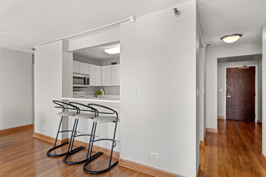 440 North Wabash Avenue, Unit 4706 Chicago, IL 60611 - Photo 9 of 29 a view of a room with wooden floor and cabinets
