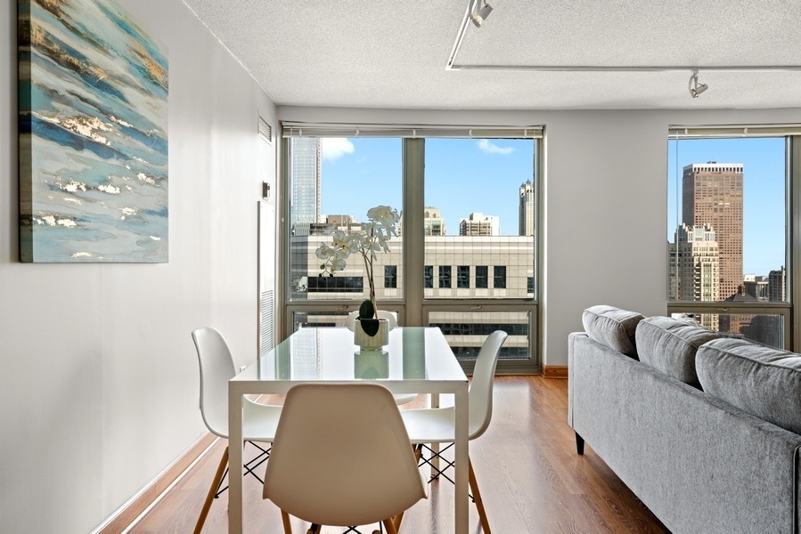 440 North Wabash Avenue, Unit 4706 Chicago, IL 60611 - Photo 10 of 29 a living room with furniture fireplace and a large window