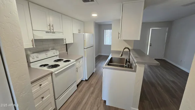 a kitchen with sink a stove and refrigerator