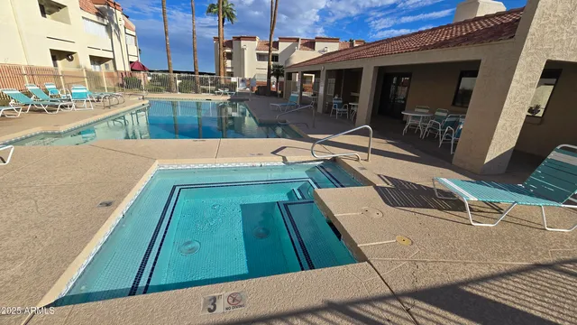 a view of a swimming pool with seating area
