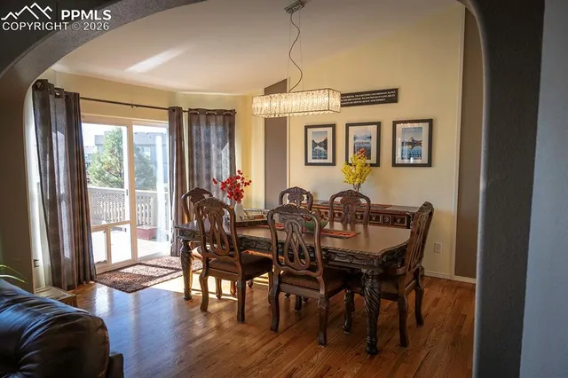 a view of a dining room with furniture window and wooden floor