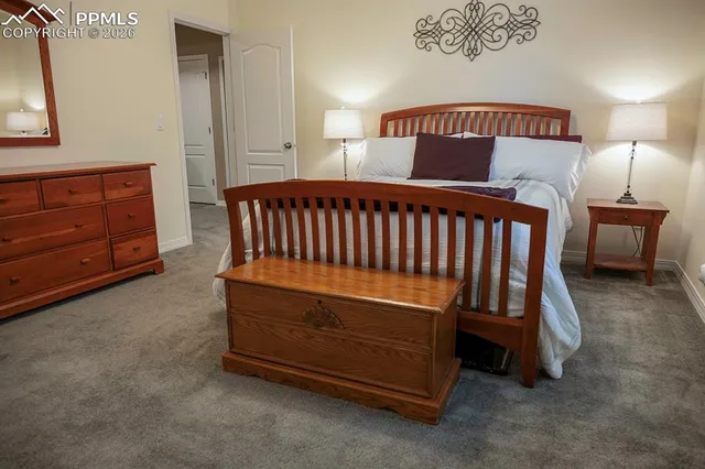a bedroom with a bed and a night stand