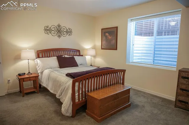 a spacious bedroom with a bed and a window