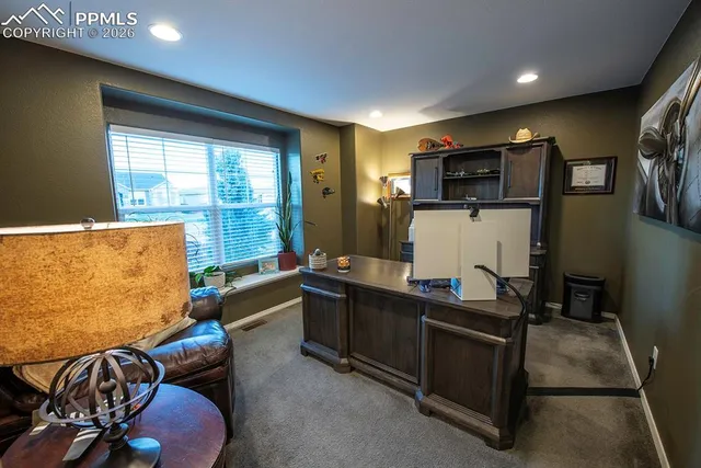 a dining room with furniture and a window