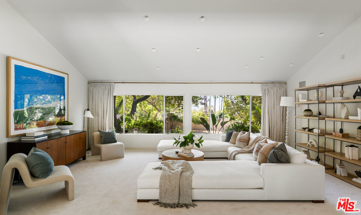811 North Hillcrest Road Beverly Hills, CA 90210 - Photo 11 of 28 a living room with furniture and a large window