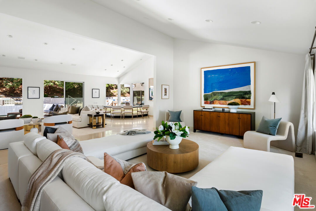 811 North Hillcrest Road Beverly Hills, CA 90210 - Photo 12 of 28 a living room with furniture kitchen view and a large window