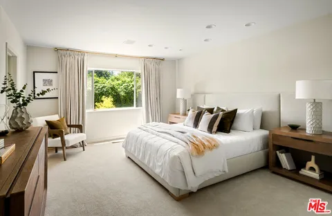 a bed room with a bed and a chair