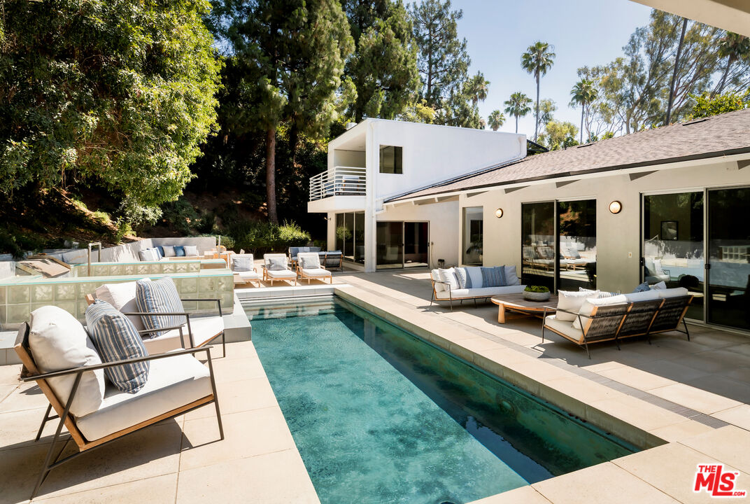 811 North Hillcrest Road Beverly Hills, CA 90210 - Photo 26 of 28 a view of a house with a backyard and sitting area