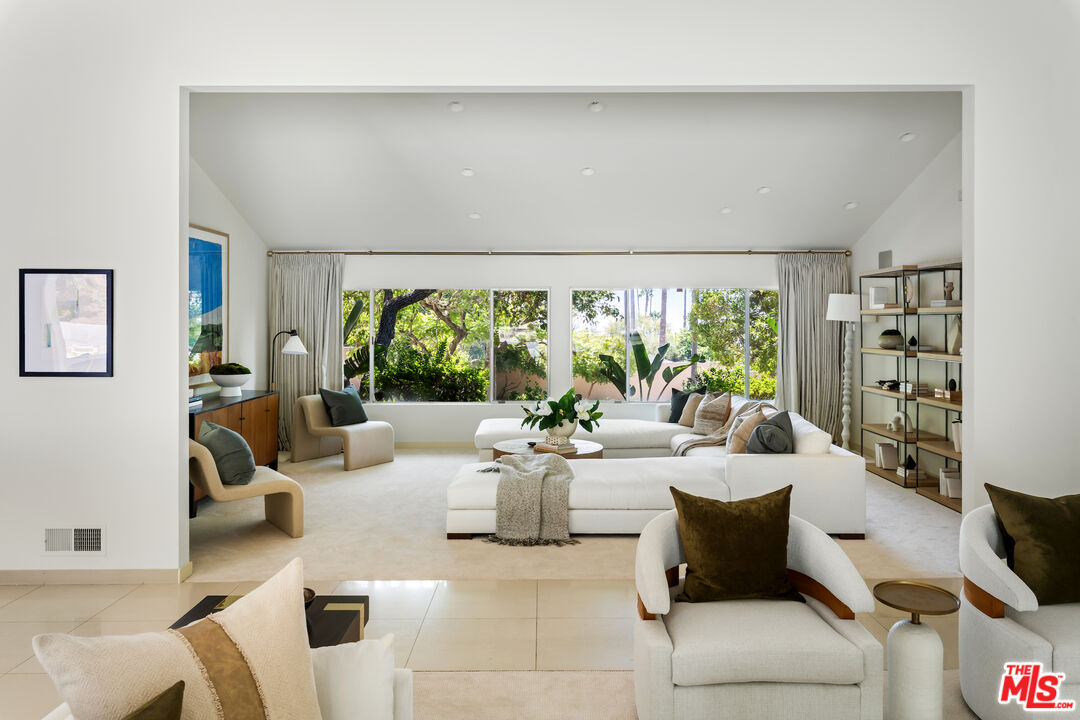 811 North Hillcrest Road Beverly Hills, CA 90210 - Photo 10 of 28 a living room with furniture and a large window