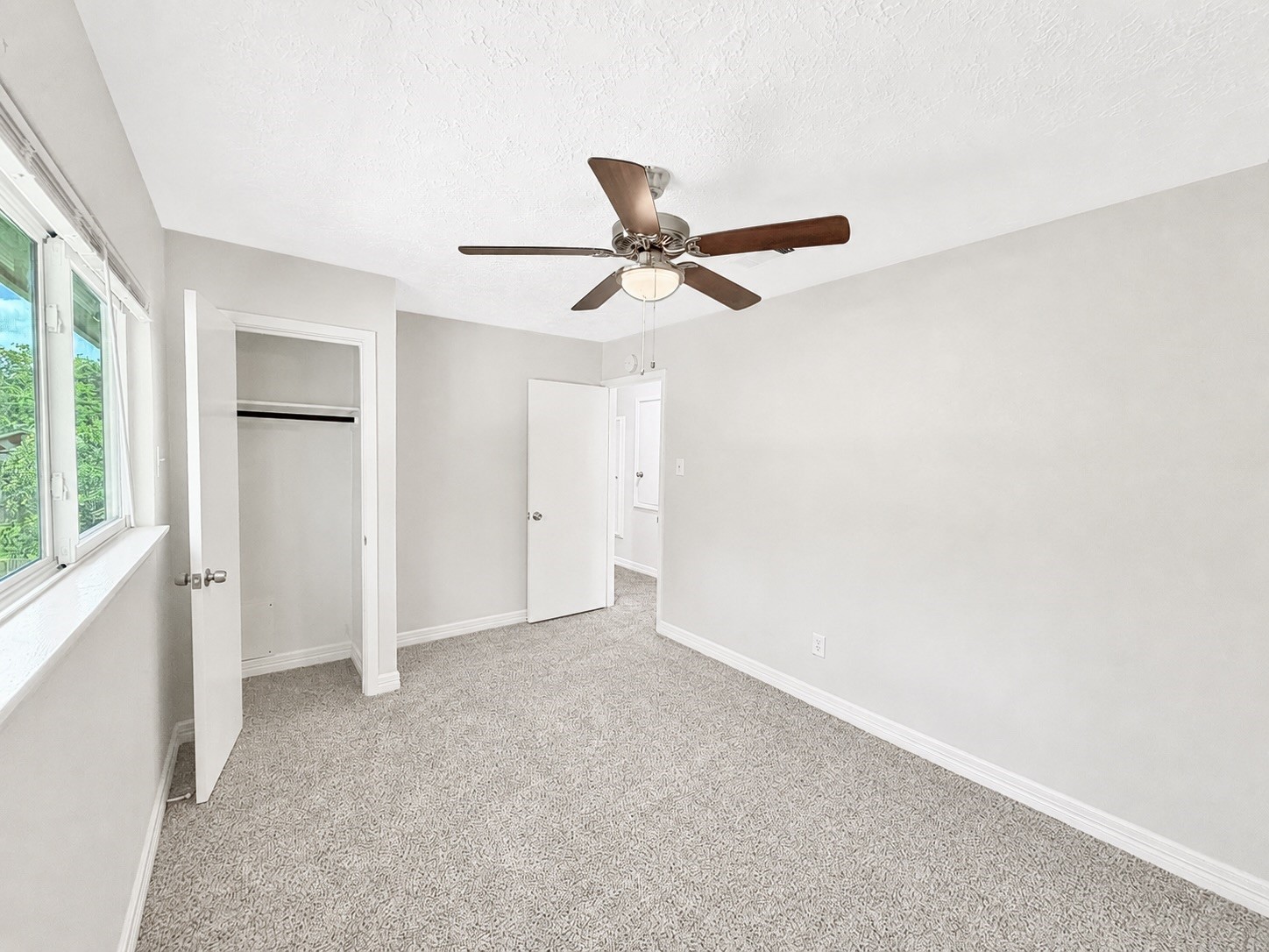 8407 Riverside Walk Lane Houston, TX 77064 - Photo 29 of 33 Secondary bedroom with plush new carpet, ceiling fan, and a bright, inviting feel.