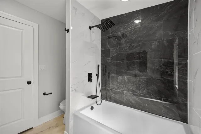 a bathroom with a shower and a sink